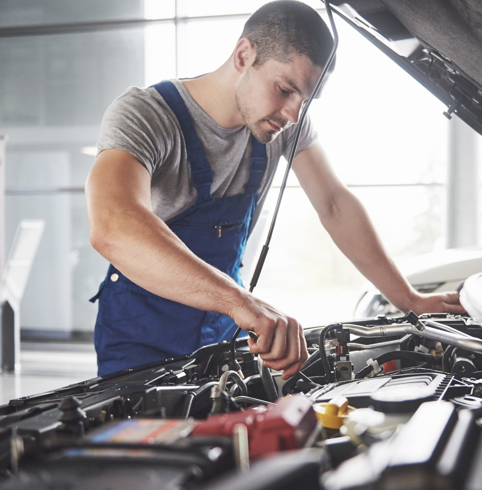 Auto mechanic working in garage. Repair service